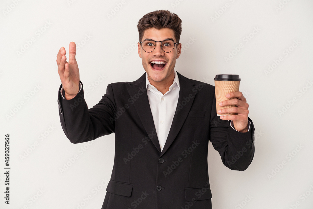 Young business caucasian man holding take away coffee isolated on white background receiving a pleasant surprise, excited and raising hands. Young business caucasian man holding take away coffee isolated on white background receiving a pleasant surprise, excited and raising hands.