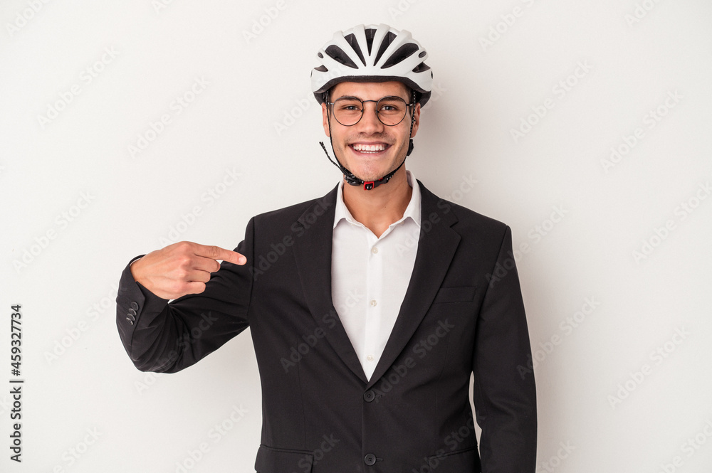Young business caucasian man holding bike helmet isolated on white background person pointing by hand to a shirt copy space, proud and confident Young business caucasian man holding bike helmet isolated on white background person pointing by hand to a shirt copy space, proud and confident