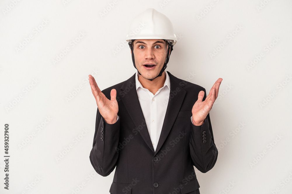 Young architect caucasian man isolated on white background surprised and shocked. Young architect caucasian man isolated on white background surprised and shocked.