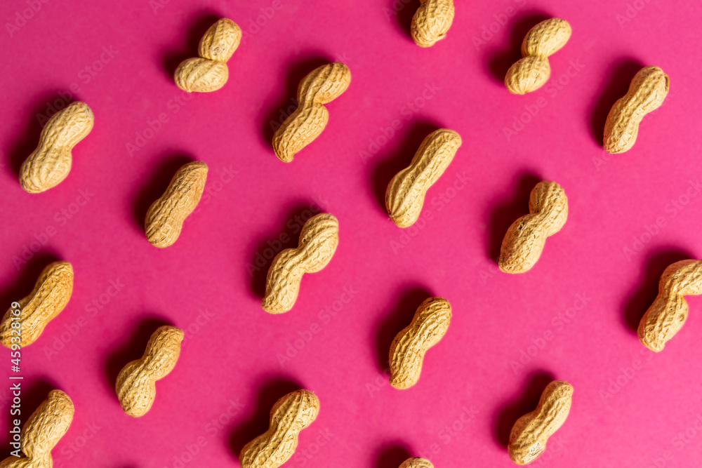 Peanut pattern on pink background. Flat lay.
