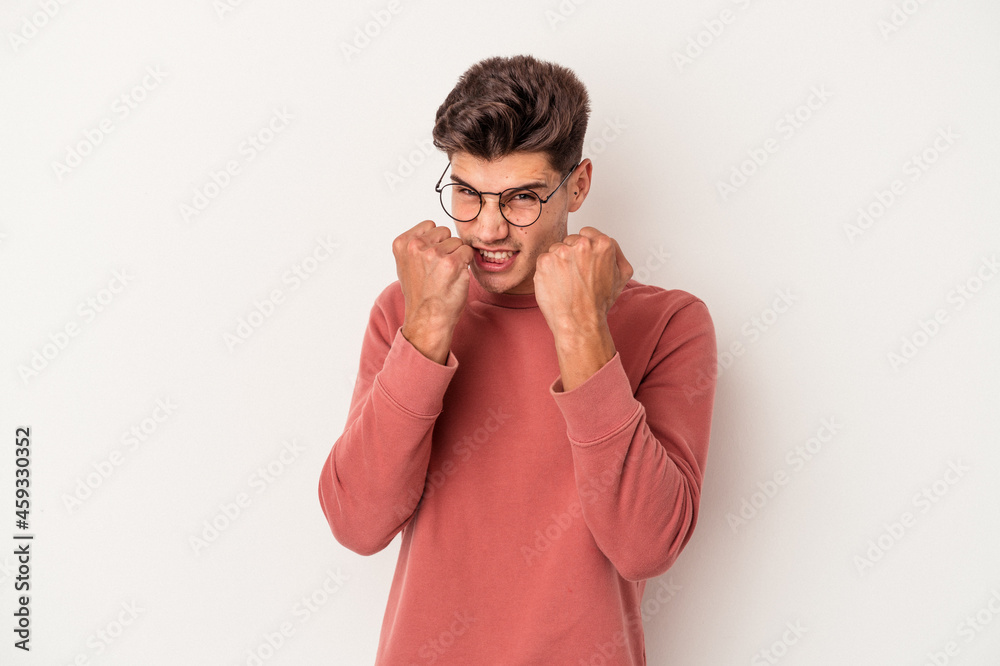 Young caucasian man isolated on white background throwing a punch, anger, fighting due to an argument, boxing. Young caucasian man isolated on white background throwing a punch, anger, fighting due to an argument, boxing.