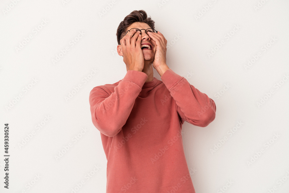 Young caucasian man isolated on white background laughs joyfully keeping hands on head. Happiness concept. Young caucasian man isolated on white background laughs joyfully keeping hands on head. Happiness concept.