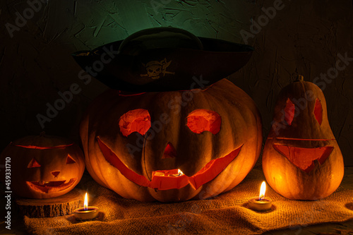 Halloween pumpkins(jack-o'-lantern) on a gray background with pirate hat

