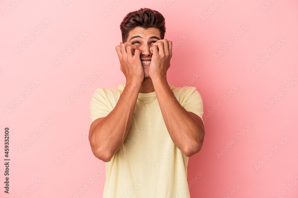 Young caucasian man isolated on pink background whining and crying disconsolately. Young caucasian man isolated on pink background whining and crying disconsolately.