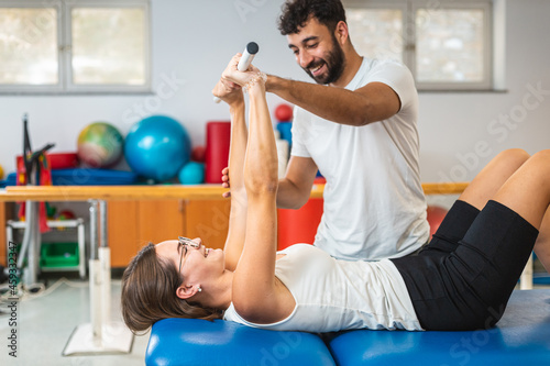 Принти на полотні Woman doing exercises with medical bar, in a supine position
