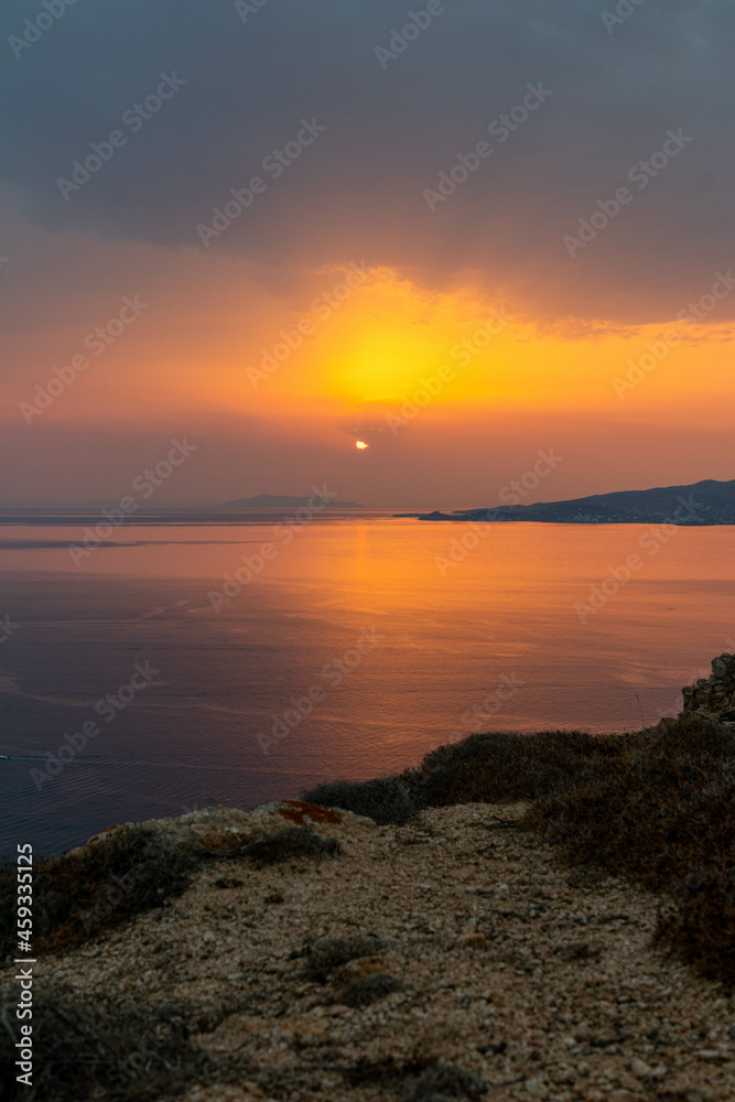 Coastline View of Sun Peaking Through Clouds in Mykonos Greece