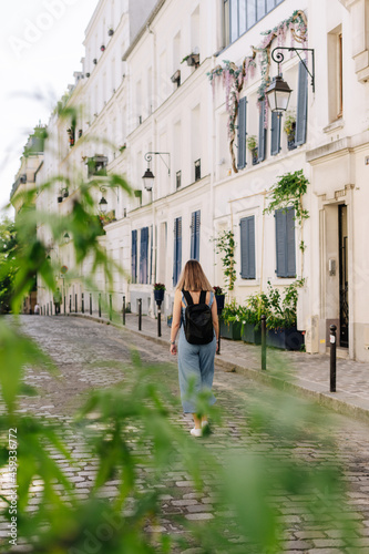 Tourist with a backpack walking by the streets of Paris © Ruben Chase