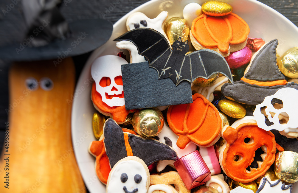 candy bowl of cookies, candy, chocolates and sweets, Halloween Jack o Lantern - Trick or Treat Halloween card dark background