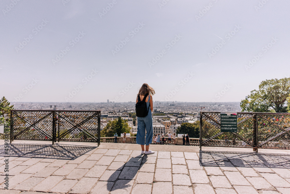 Tourist contemplating Paris from Montmartre