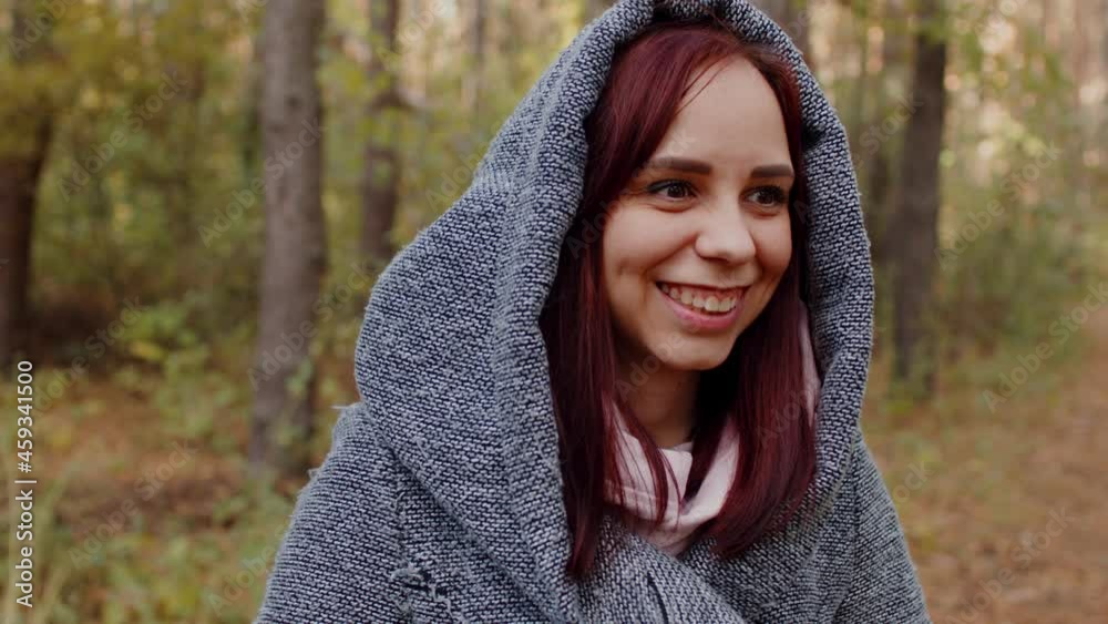 Close up portrait of beautiful and cheerful woman dreamily looking away against the background of an autumn forest Close up portrait of beautiful and cheerful woman dreamily looking away against the background of an autumn forest