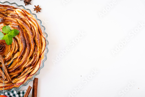 Half of apple pie on white background with copy space
