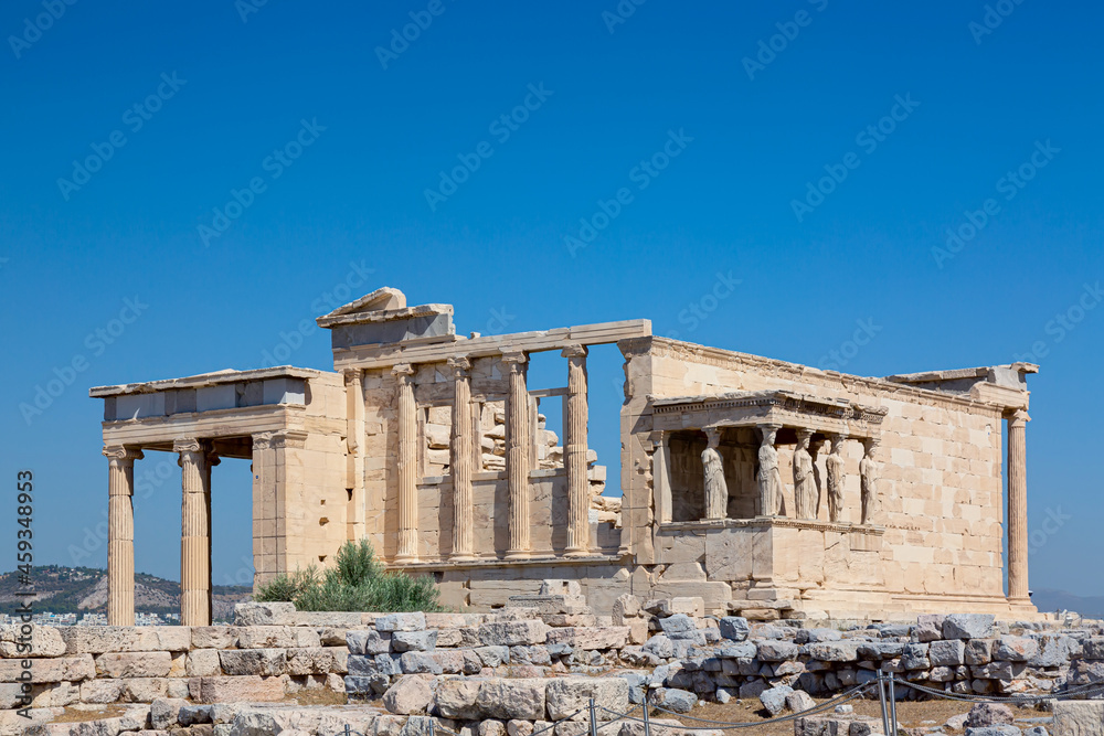 Ancient Erechtheion or Erechtheum temple with Caryatid Porch on the Acropolis, Athens, Greece. World famous landmark at the Acropolis Hill.