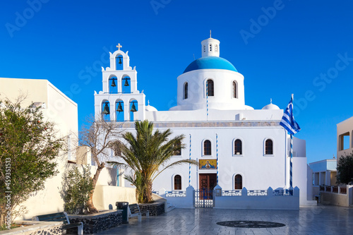 Traditional greek orthodox church in the center of Oia village, Santorini island, Greece.