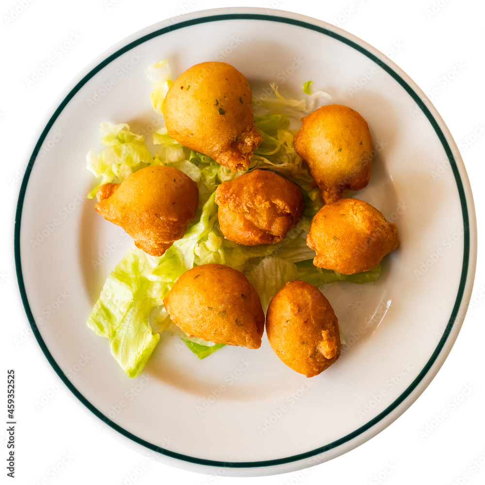 Cod fritters. Bunoles de bacalao. Spanish cuisine. Isolated over white background