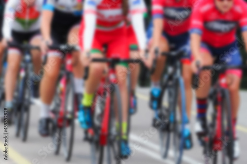 Cycling competition, blur image of asphalt road and bikes. Cycling race