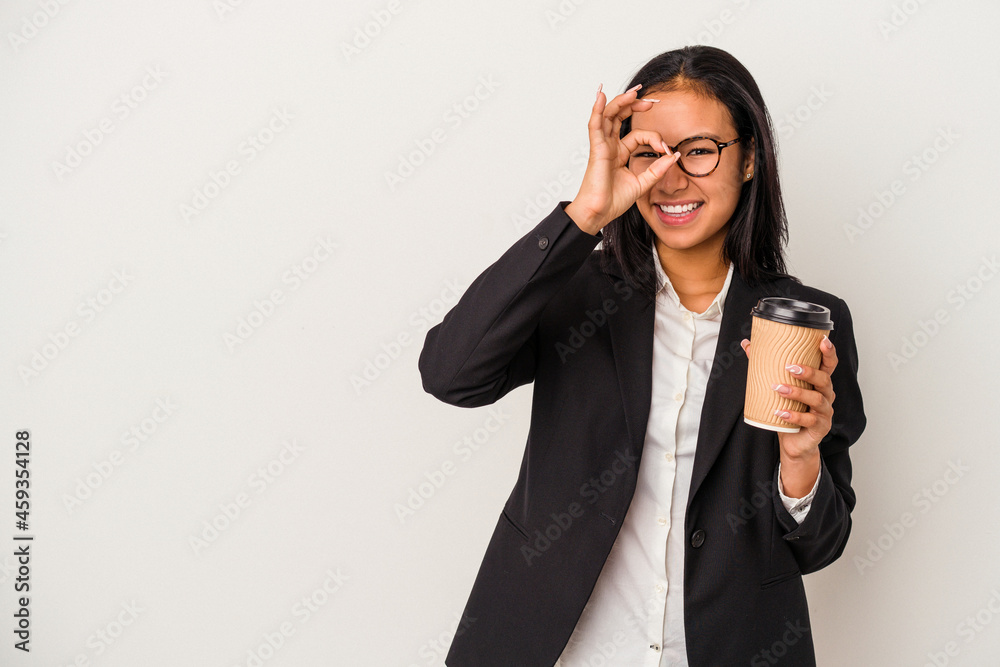 Young business latin woman holding a take away coffee isolated on white background excited keeping ok gesture on eye. Young business latin woman holding a take away coffee isolated on white background excited keeping ok gesture on eye.