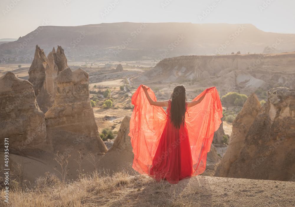 woman in red dress in Cappadocia Turkey, desert landscape