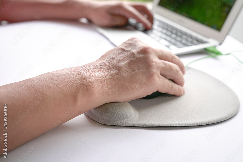 Man's fingers clicking on mouse, resting his wrist on wrist rest. Close up shot. Man's fingers clicking on mouse, resting his wrist on wrist rest. Close up shot.