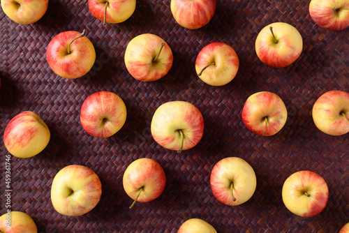 Fresh red apple fruit on red background, Flat lay