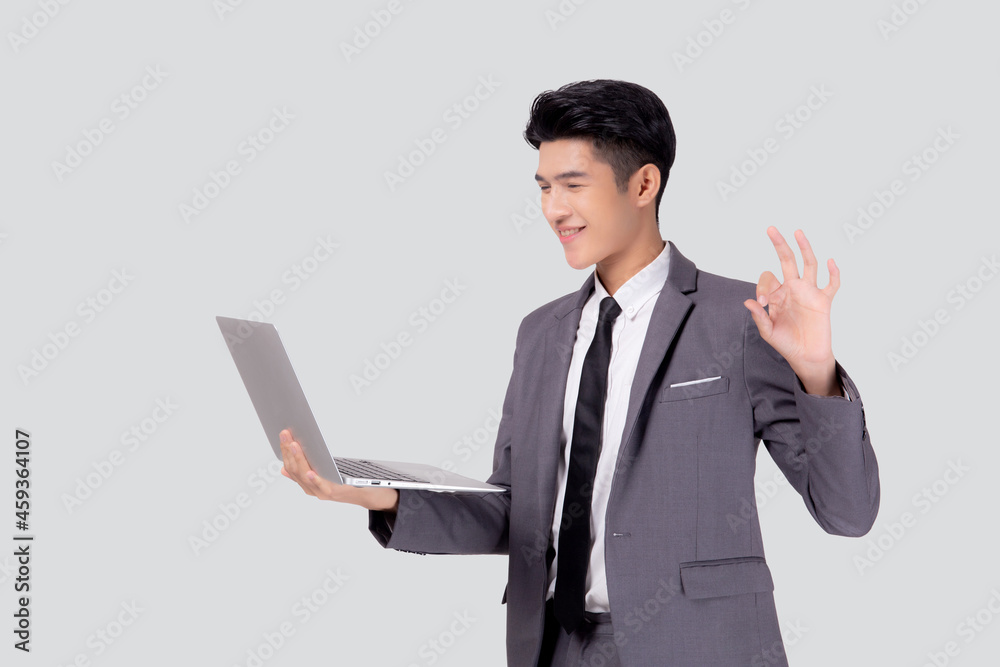 Young asian business man standing work on laptop computer to internet online isolated on white background, businessman confident and notebook, freelance with success, marketing and communication. Young asian business man standing work on laptop computer to internet online isolated on white background, businessman confident and notebook, freelance with success, marketing and communication.