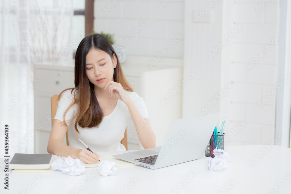Young asian woman working with laptop computer think idea project and paper crumpled having problem on table at home, girl using notebook with frustrated and trouble, business and freelance concept. Young asian woman working with laptop computer think idea project and paper crumpled having problem on table at home, girl using notebook with frustrated and trouble, business and freelance concept.