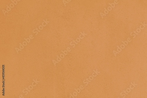 Antique yellow painted concrete wall in vintage style texture and background seamless