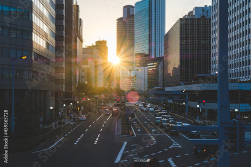 Osaka downtown area in the early morning with bright sunlight and tall skyscrapers. The early morning city landscape 