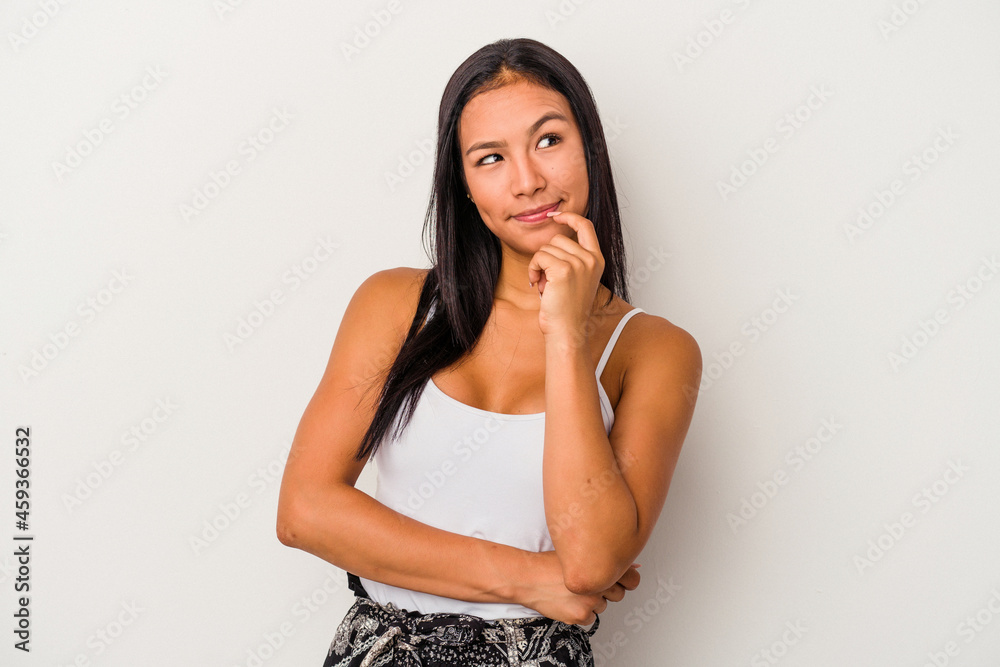 Young latin woman isolated on white background relaxed thinking about something looking at a copy space. Young latin woman isolated on white background relaxed thinking about something looking at a copy space.