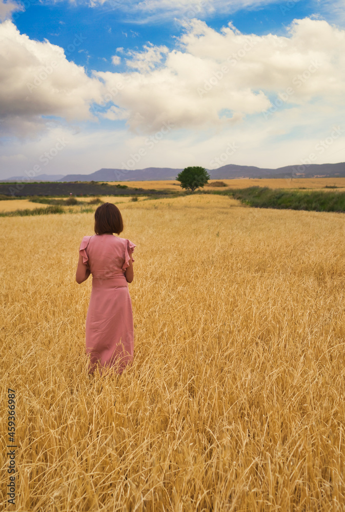 woman posing in wheat field.