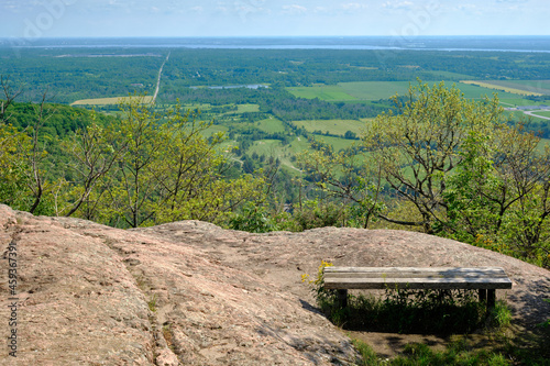 Bench overlooking golf course and farmland in Gatineau Park