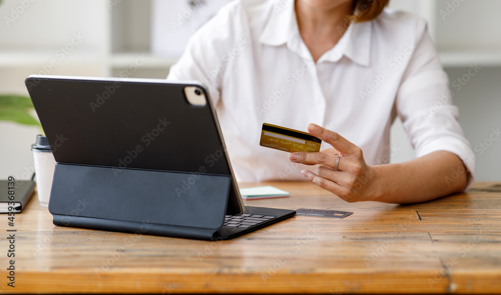 Close up of female hand doing online banking or online payment on a smartphone and tablet. Close up of female hand doing online banking or online payment on a smartphone and tablet.