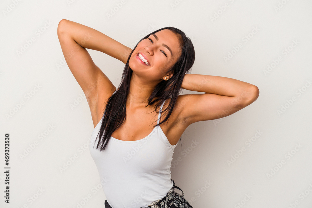 Young latin woman isolated on white background stretching arms, relaxed position. Young latin woman isolated on white background stretching arms, relaxed position.