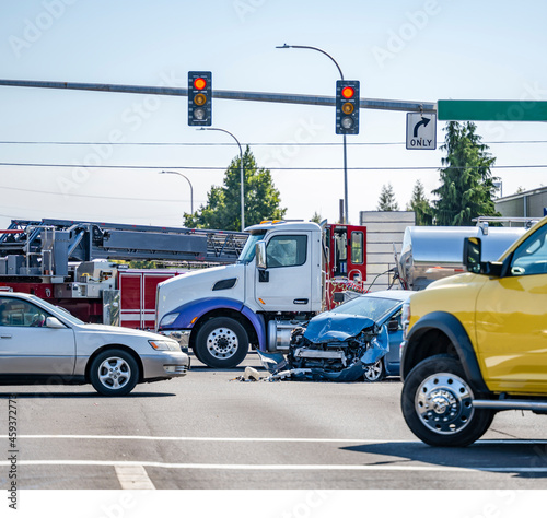 Fotografija Intersection accident involving a car and a big rig semi truck with tank semi tr