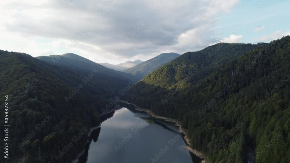 Aerial shot flying over the Fagaras mountain range and Lake Vidraru in Romania Aerial shot flying over the Fagaras mountain range and Lake Vidraru in Romania