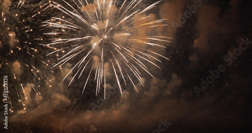 Golden Firework celebrate anniversary happy new year 2022, 4th of july holiday festival. Gold firework in the night time celebrate national holiday. Countdown to new year 2022 gold party time event