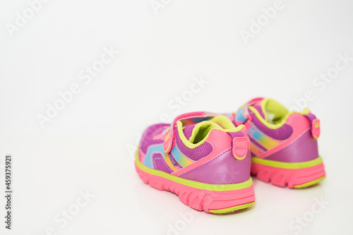 color kid sneakers shoes on floor rear view soft focus
