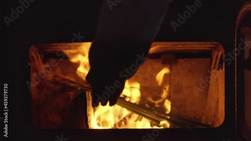 Heartbroken Lover Burns Flowers in Wood Fire Stove, Close Up photo