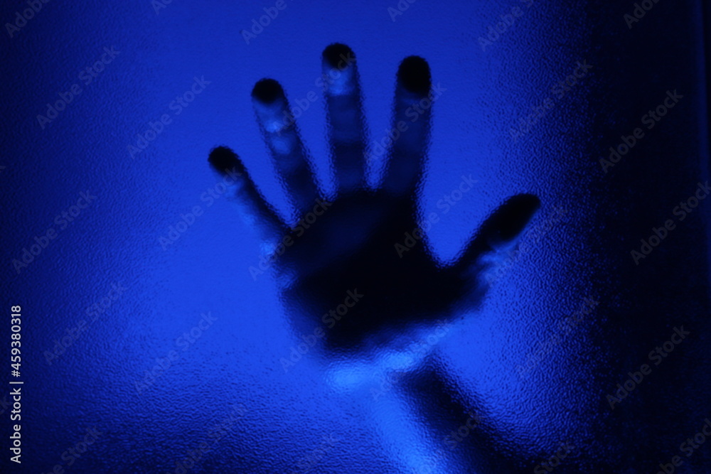 Silhouette of an hand behind the frosty glass window. Silhouette of an hand behind the frosty glass window.