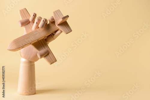 Bilde på lerret Hand with wooden airplane on color background. Concept of hostage