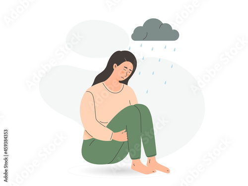 Sad lonely woman to get rid of depression A young unhappy girl sits and hugs her knees