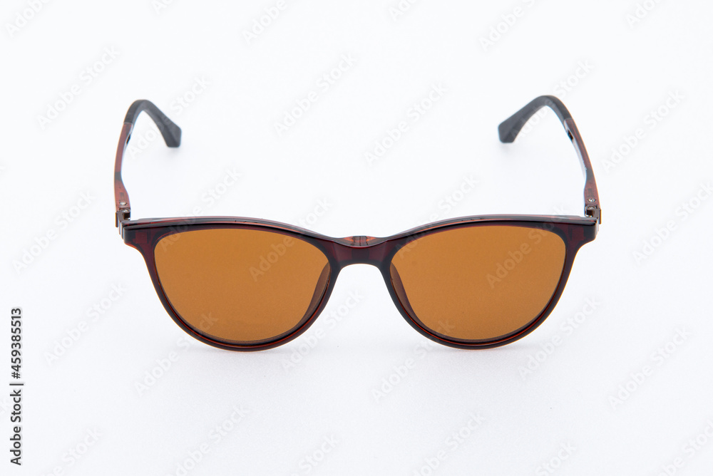 Fashion sunglasses brown frames and orange lens on white background. Fashion sunglasses brown frames and orange lens on white background.