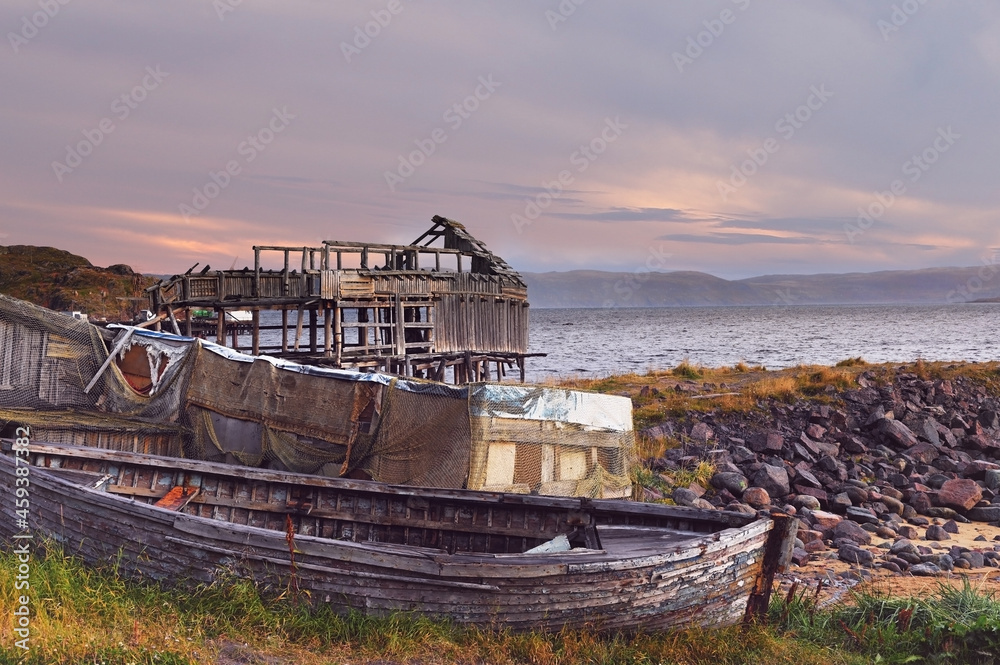 Old wooden boat on the shore of the Barents Sea