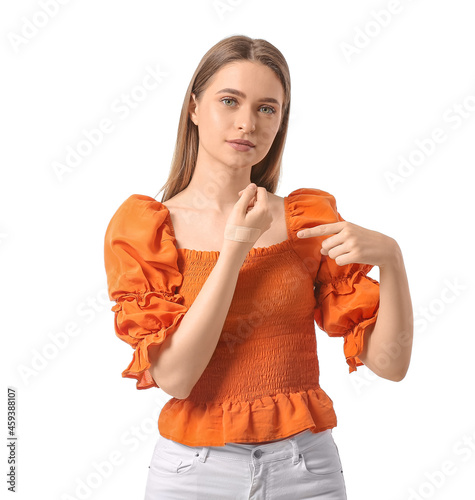 Young woman pointing at adh...