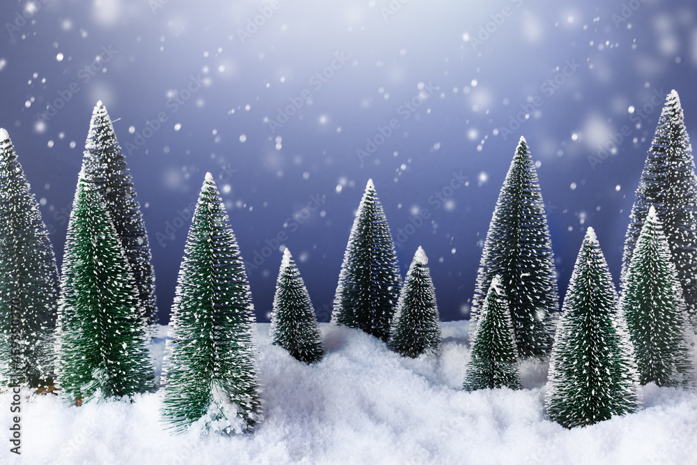 Winter forest with Christmas trees in snowy night.  Christmas winter greeting card.
