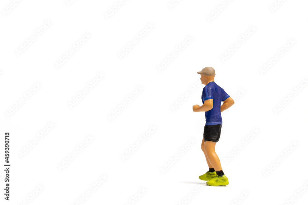 Miniature people, Man in fitness wear running on white background and space for text Miniature people, Man in fitness wear running on white background and space for text