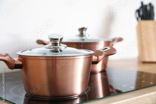 Copper cooking pot on stove in kitchen, closeup
