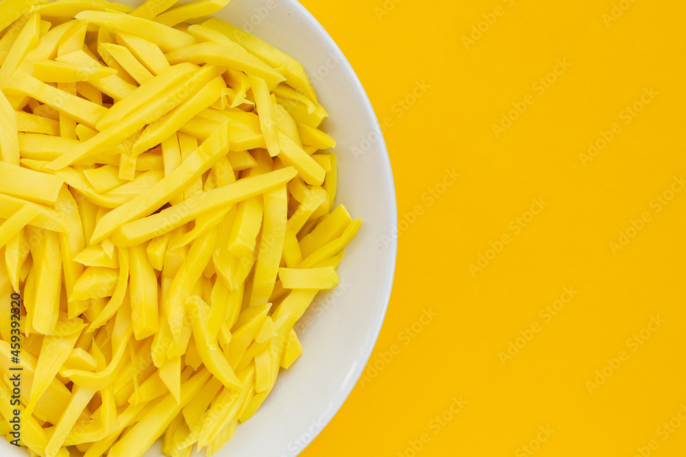 Preserved bamboo shoot in white plate on yellow background. Preserved bamboo shoot in white plate on yellow background.