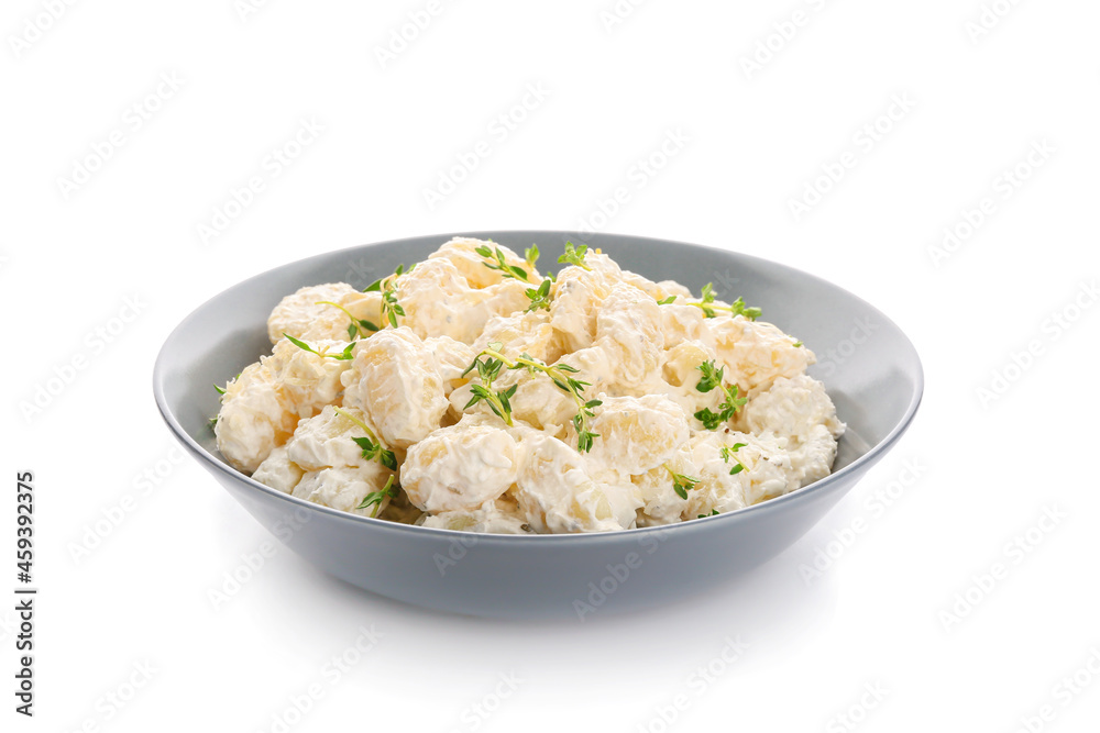 Bowl of delicious gnocchi with creamy sauce on white background Bowl of delicious gnocchi with creamy sauce on white background