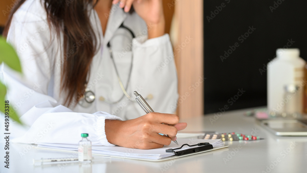 Cropped shot of female practitioner or pharmacist writing a medical prescription Cropped shot of female practitioner or pharmacist writing a medical prescription