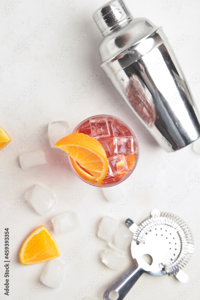 Glass of tasty Negroni cocktail on light background Glass of tasty Negroni cocktail on light background